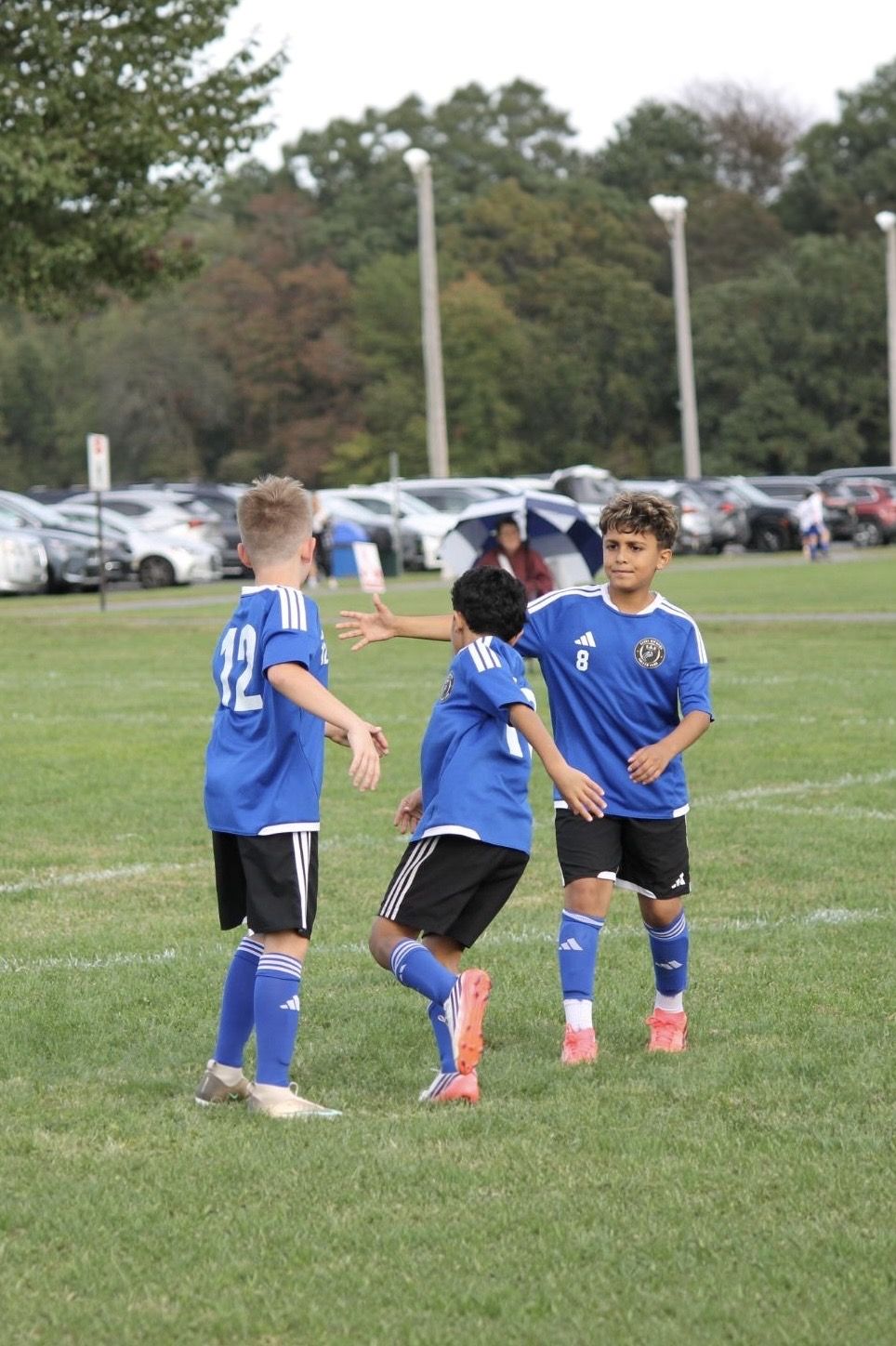 EKS U11 players celebrating a goal